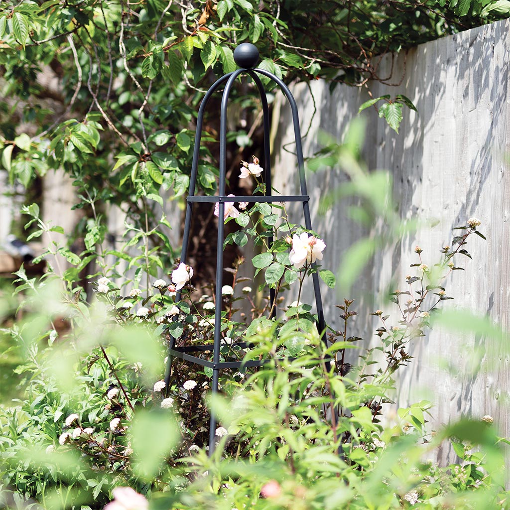 Classic Square Obelisk against fence